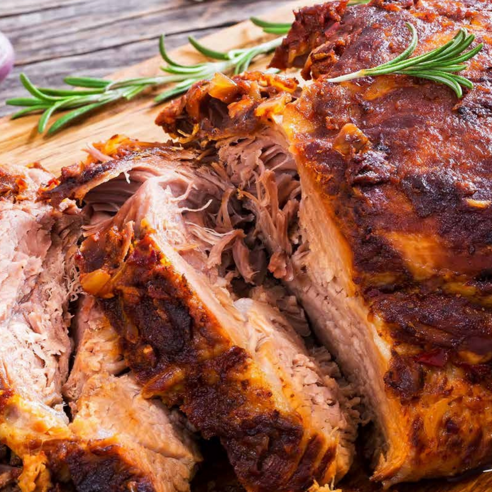 Roasted lamb shoulder with sticky date, pistachio, and lemon gravy on a wooden board. Braising is a cooking skill that will help you live happily ever after in the kitchen. Perfect for entertaining.