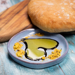 Bread with olive oil and ciabatta on a wooden board. Learn high hydration stretch and fold dough.